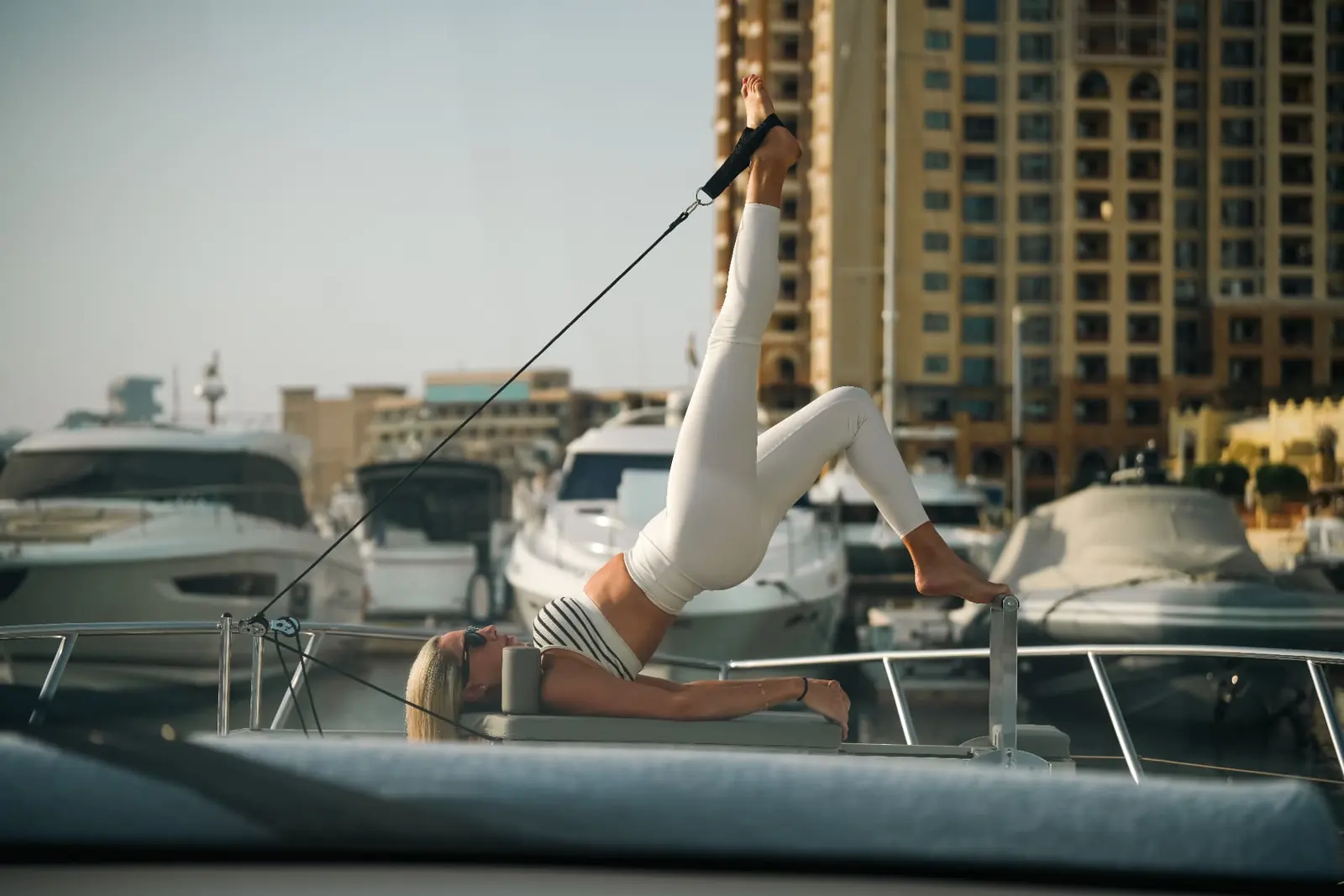 Pilates reformer session on a yacht at Dubai Marina