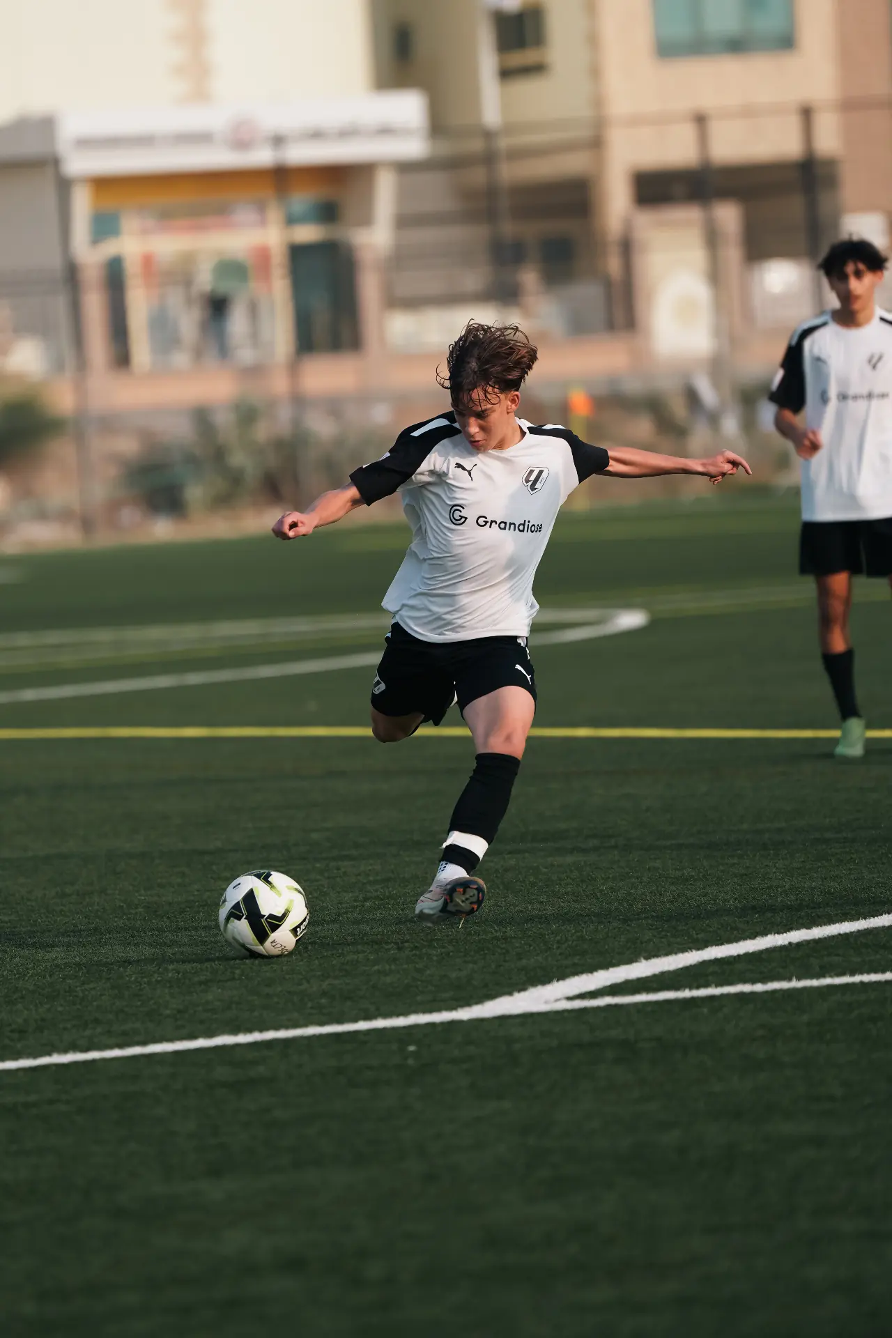 Academy player striking the ball