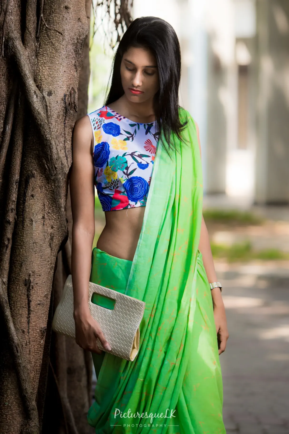 Green saree editorial portrait by a banyan tree
