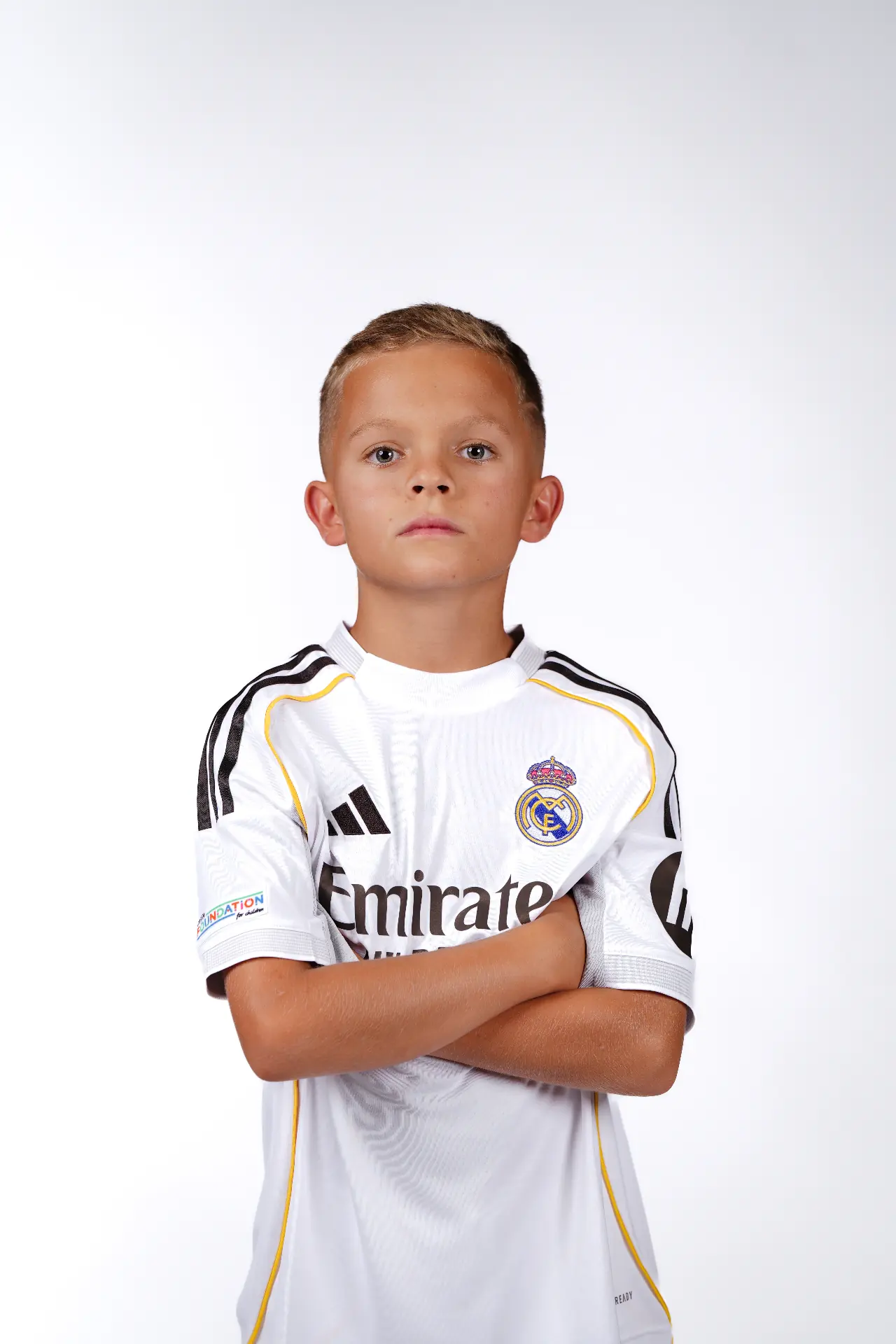 Studio portrait — Real Madrid academy kit on white