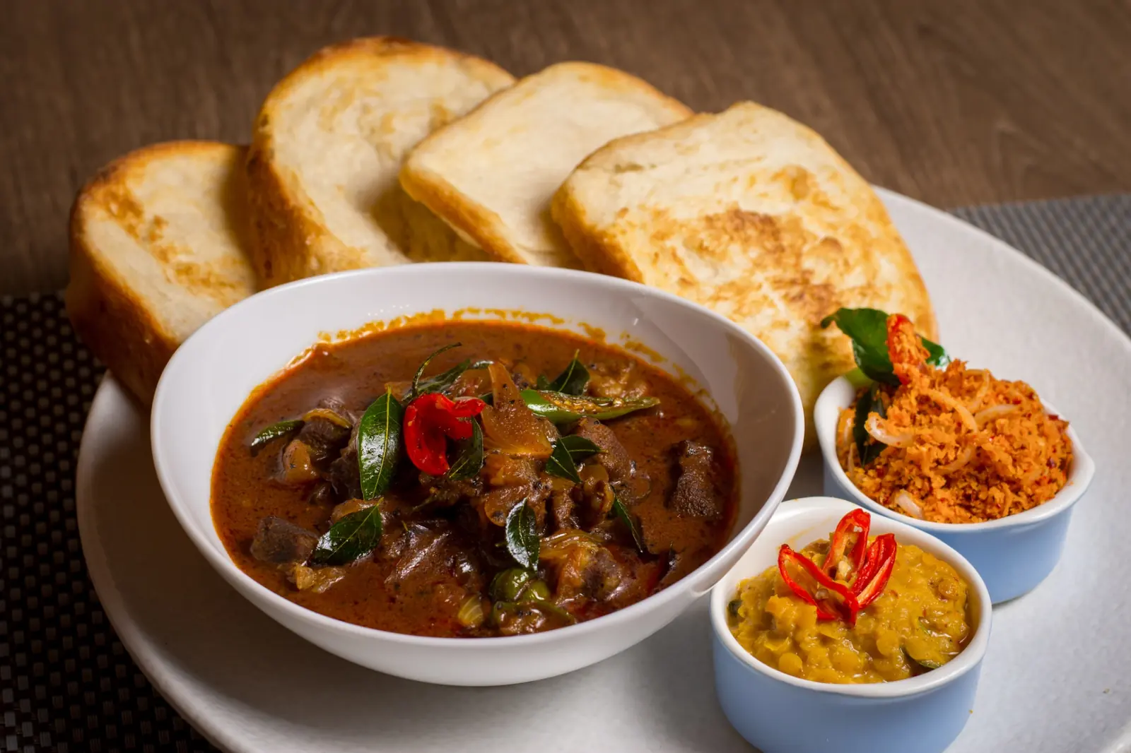 Sri Lankan curry with toasted bread and sambols