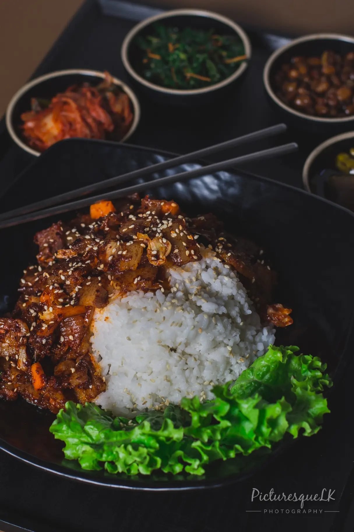 Spicy beef rice bowl with banchan